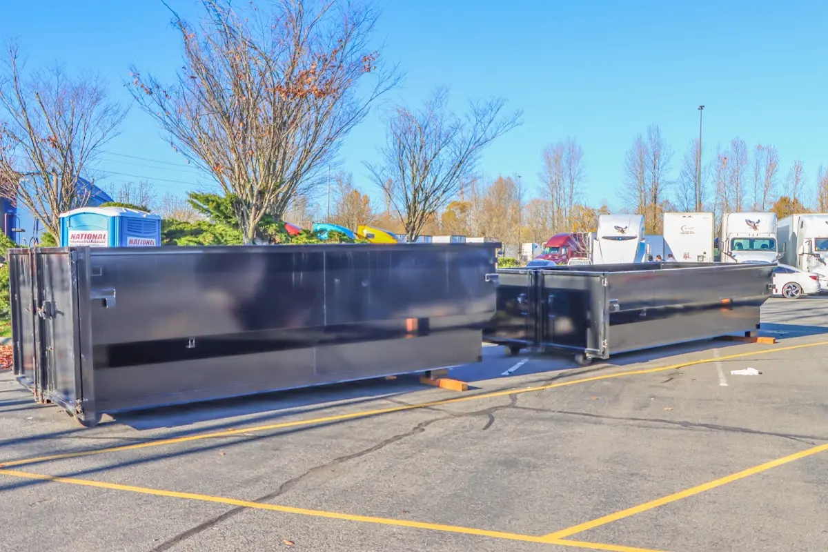 Professional dumpster rental service with roll-off container on residential driveway in Sheffield